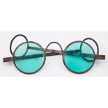 A pair of Georgian steel framed spectacles: with circular cyan coloured glass,