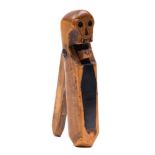 A 19th century treen nut cracker with carved skull decoration:,
