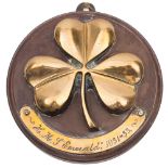 A brass tompion for the Emerald-class light cruiser HMS Emerald (D66): with three leaf clover over