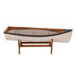 A scale model of a rowing boat 'Hanah': the white painted plank and pinned hull, fitted seats,