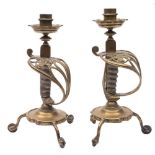A pair of Victorian sword hilt gilt and spur gilt brass candlesticks: each sconce with tridecagon
