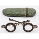 A pair of white metal 'Martin's Margins' spectacles: the lenses within horn mounts,