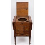 A ship's teak drop flap enclosed washstand: the double hinged top enclosing wash bowl and cup wells,