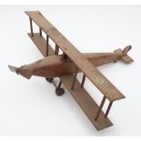 A scratch built wooden model of a biplane: with RAF roundels to wings and fuselage, 51cm long.