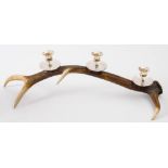 A four point antler, triple sconce silver plated candelabrum:, 56cm long.