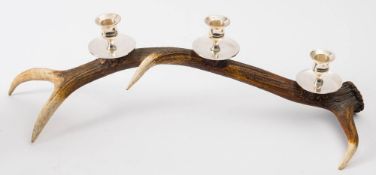 A four point antler, triple sconce silver plated candelabrum:, 56cm long.