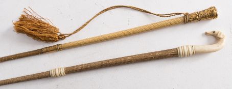 Two 19th century lady's riding crops: one with carved ivory dog's head finial with ivory ferrule,