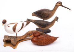 A group of four carved and painted wooden game birds: comprising a half block model of a duck,