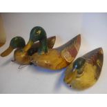 A set of three graduated carved wooden and polychrome decorated Mallard duck decoys: 34cm, 32cm,