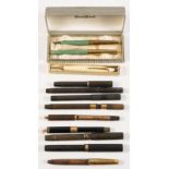 A group of nine vintage fountain pens: including a Waterman's 9ct gold mounted pen with