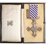 A George V Distinguished Flying Cross: dated 1945 together in box of issue in a display case,