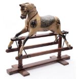 An early 20th century rocking horse by Balfours: the carved head inset with glass eyes with open