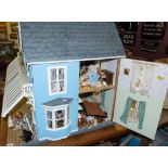 A large late 20th century Victorian style doll's house: with simulated slate roof over blue wall