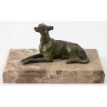 A bronze figure of a recumbent greyhound: unsigned, mounted on a marble plinth base 15cm long.