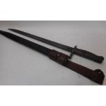 A Remington US 1917 bayonet: with 43cm fullered parkerized blade and blued fittings,