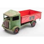 A Tri-ang tinplate lorry: green truck and chassis with red tipping bed, black rubber tyres.