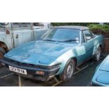 A 1980 Triumph TR7 convertible: registration 'GCV 197W' blue with black roof ,