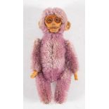 An early 20th century Schuco purple plush monkey ladies compact: with moulded face and fitted