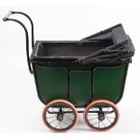 A Victorian/Edwardian child's dolls pram: of rectangular outline, with green and black coachwork,