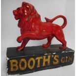 A Booths Gin advertising figure: the red painted plaster lion mounted on a rectangular base,