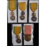 A group of four Medal Militaire with trophy suspension: together with a Commemorative Medal of the