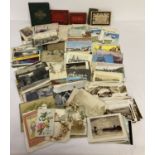 A box of assorted vintage postcards, comical cards and greetings cards.