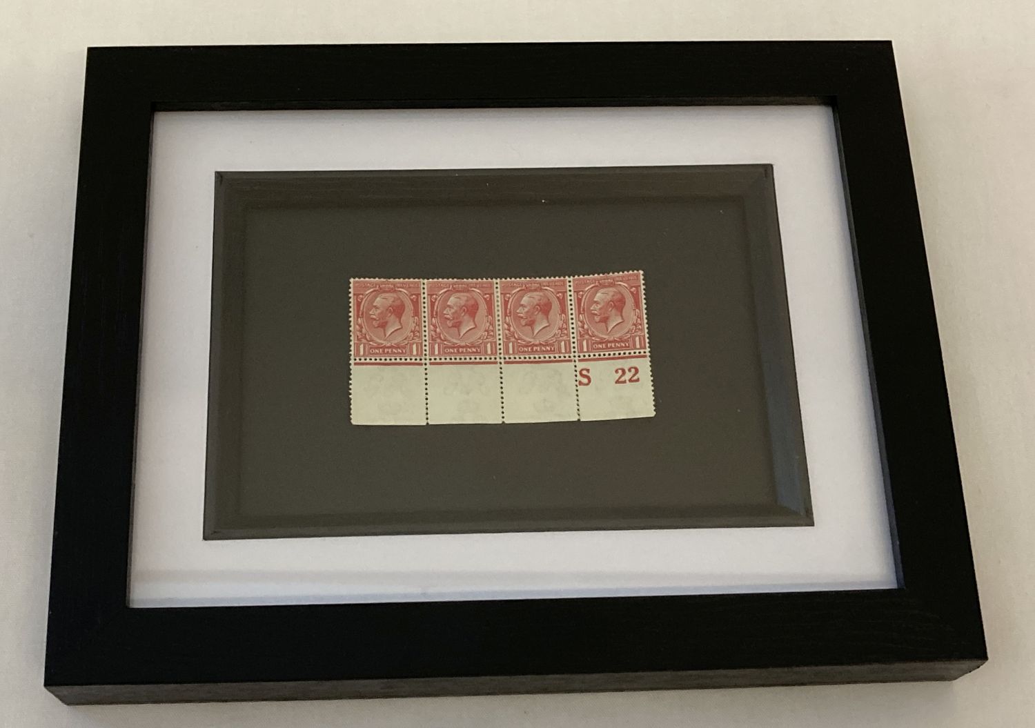 A framed and glazed S22 control block of 1929 George V red penny stamps, unfranked.