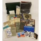 A box of assorted vintage ephemera relating to coins, stamps and collectors cards.