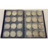 A folder containing 72 assorted white metal coins from around the world.