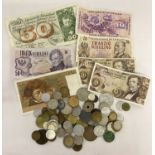 A collection of vintage and antique foreign bank notes and coins.