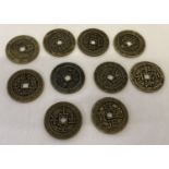 A collection of 10 brass Chinese coins/tokens with square shaped central holes.