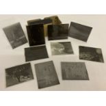 A small collection of vintage glass photographic plates to include ships.