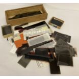 A box of assorted vintage photographic negatives.