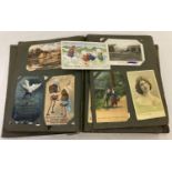 A vintage postcard album containing a quantity of assorted postcards & greetings cards.