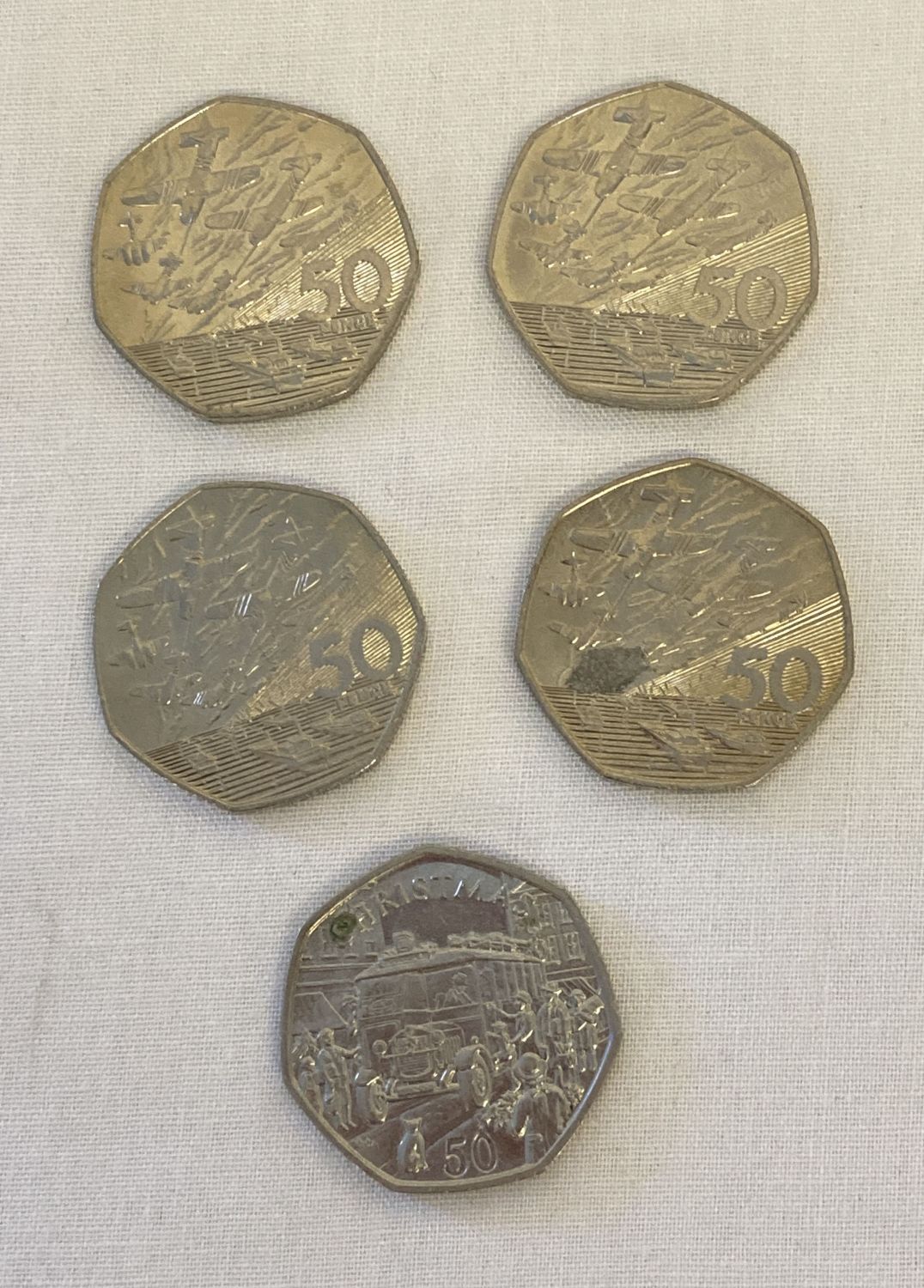 5 collectors 50p coins. An Isle Of Man 1987 Christmas coin together with 4 1994 D-Day coins.