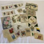 A small collection of vintage Christmas cards and silk cigarette cards.