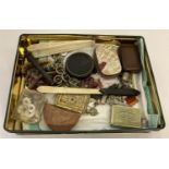 A tin of assorted antique and vintage items.