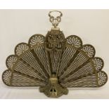 An antique expanding peacock/fan brass fire screen with pierced work detail to panels.