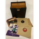 A black "His Master's Voice" record carry case containing a collection of vintage 78 records.