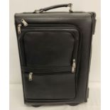 A wheeled faux leather pilot's case with combination locks.