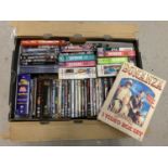 A box of mixed genre DVD's, DVD box sets and videos.