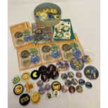 A collection of modern pin badges, some still in original packaging.