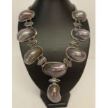 A large polished shell and peacock keshi pearl statement necklace.