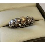 A silver bubble heart band ring by pandora with gold overlay detail to one heart.