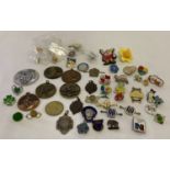A collection of vintage and modern pin and lapel badges.