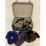 A vintage suitcase containing a collection of Royal Rangers berets, hats and neck toggles.