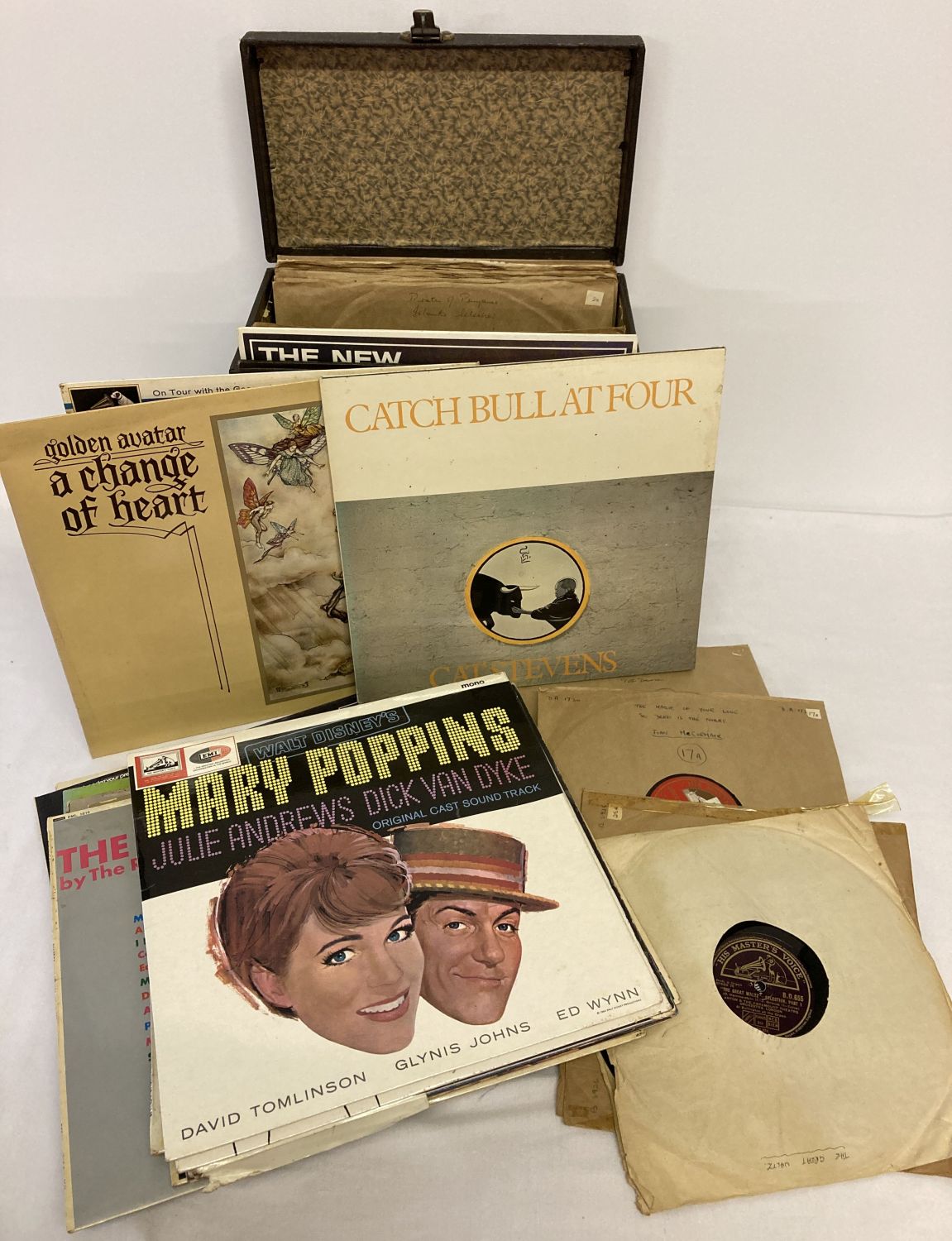 A vintage record carry case containing a collection of 78 records.