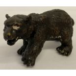A small hollow bronze figure of a bear.