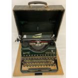 A vintage German Rheinmetall Borsig typewriter in green with gold decals.
