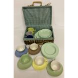 A small picnic basket containing a quantity of Gaydon Melmex ware plates, bowls, cups & saucers.